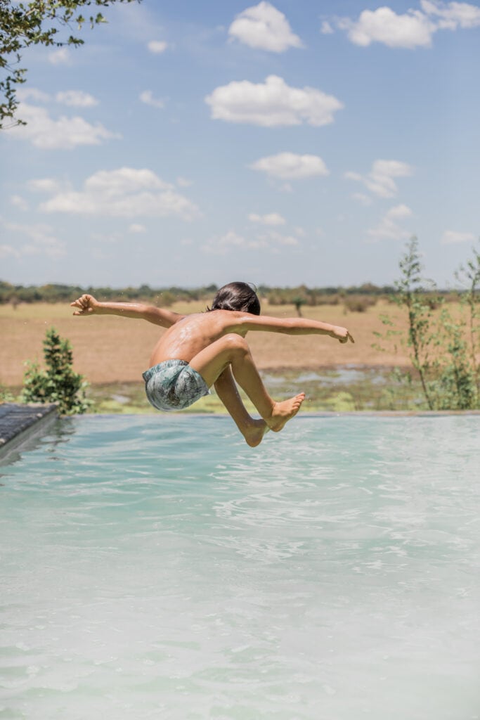 Kid jumping in pool